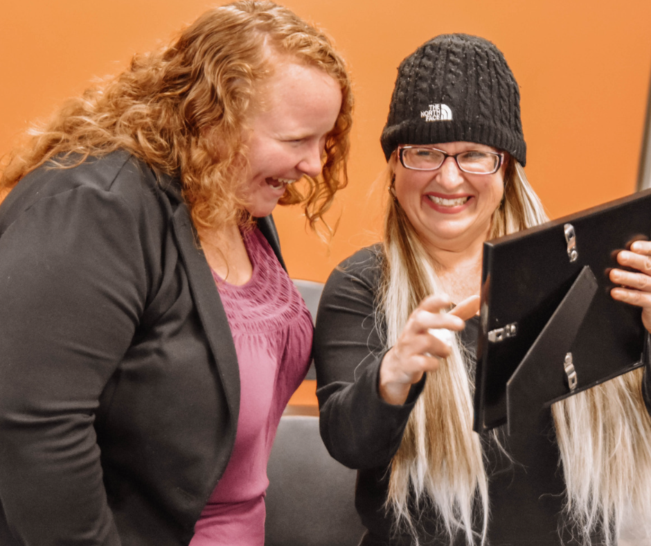Lutheran Social Services clients smiling at picture frame