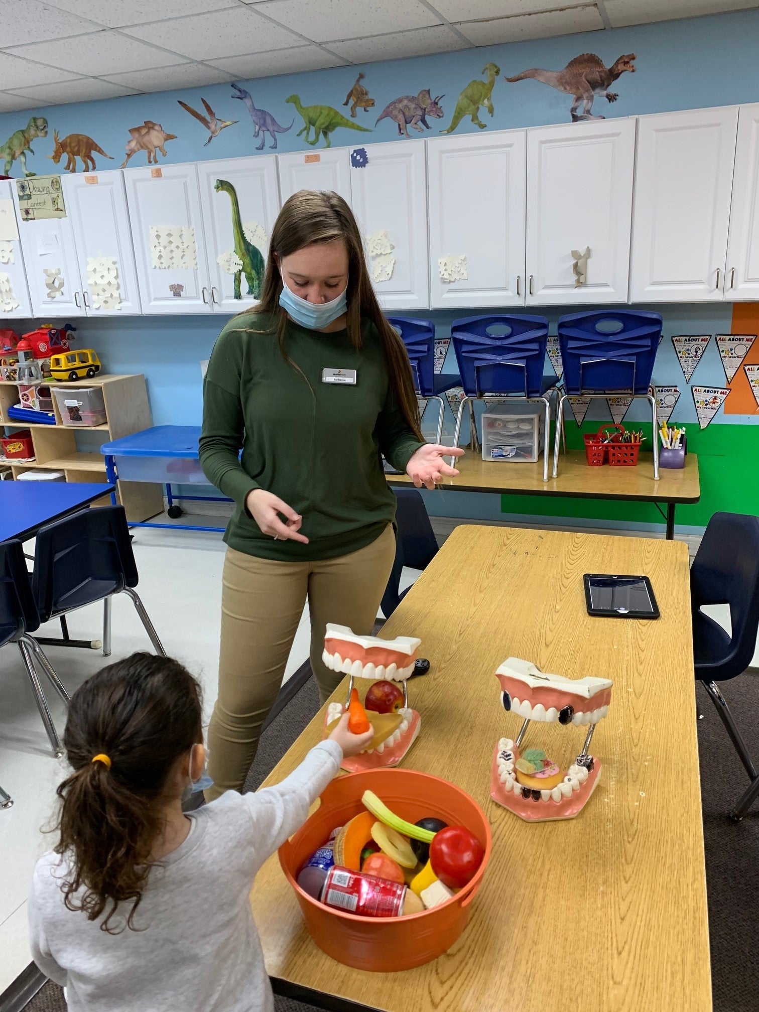 McMillen staff member teaching a student about oral health