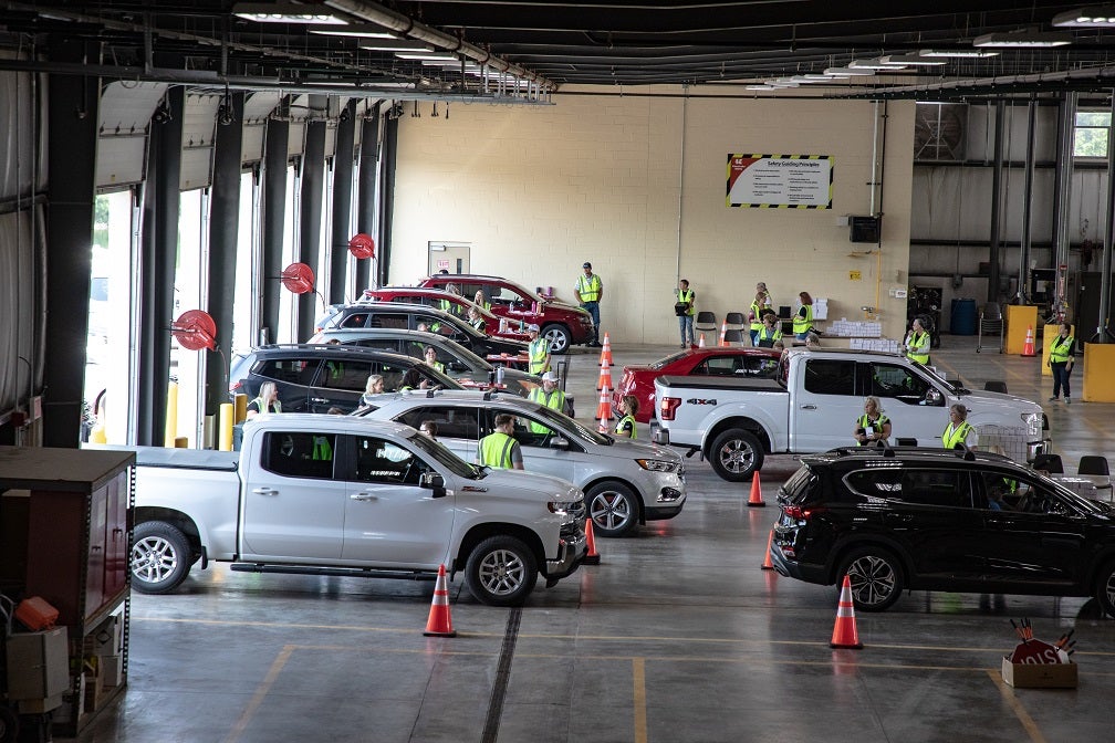 Cars drive through the KREMC facility at the annual meeting.