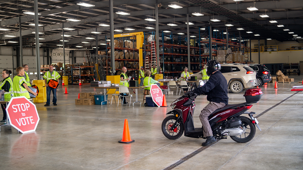 A motorcycle approaches the garage at last year's KREMC Annual Drive-Thru Meeting.