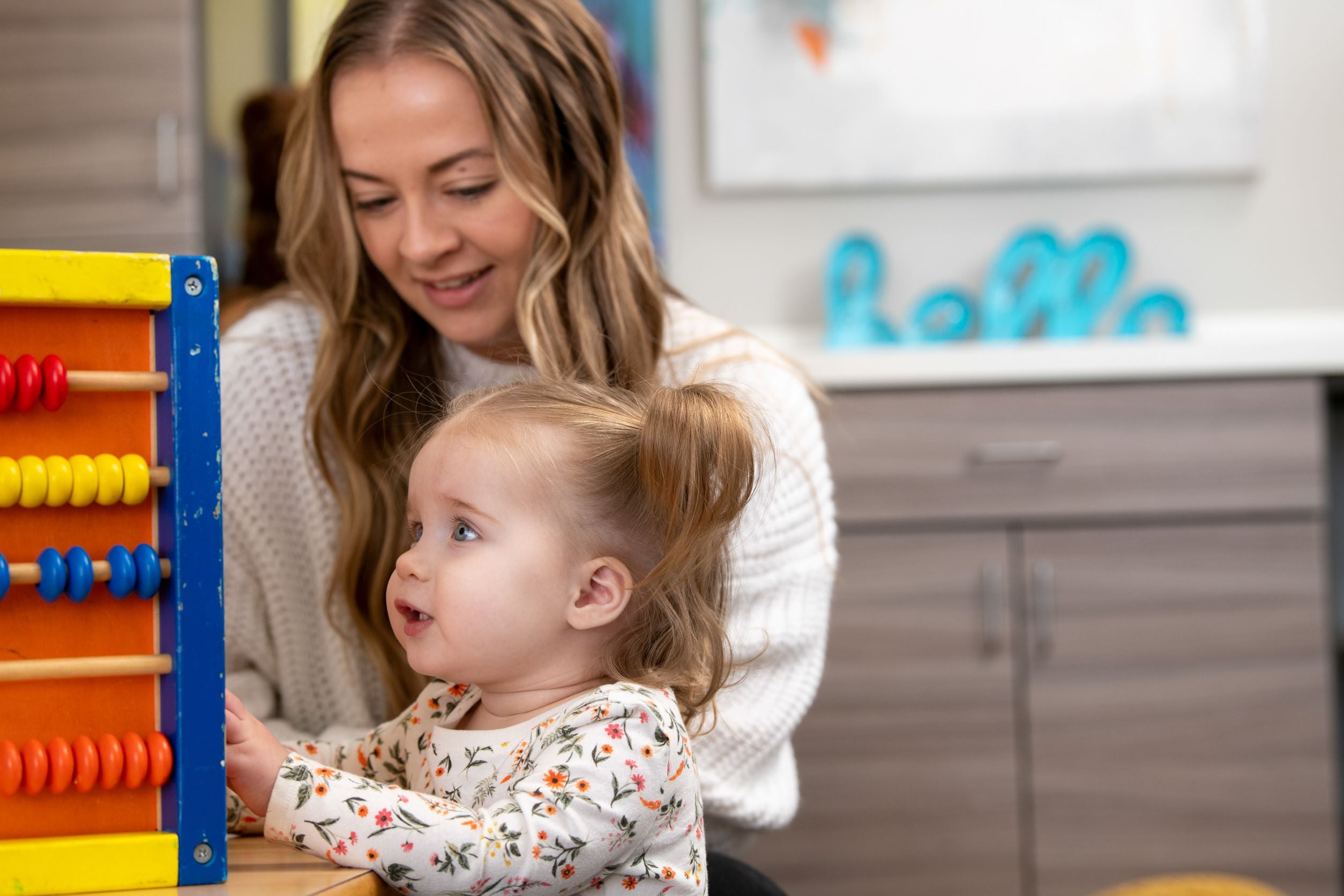Another adult playing with a toddler at a Hope's Harbor house