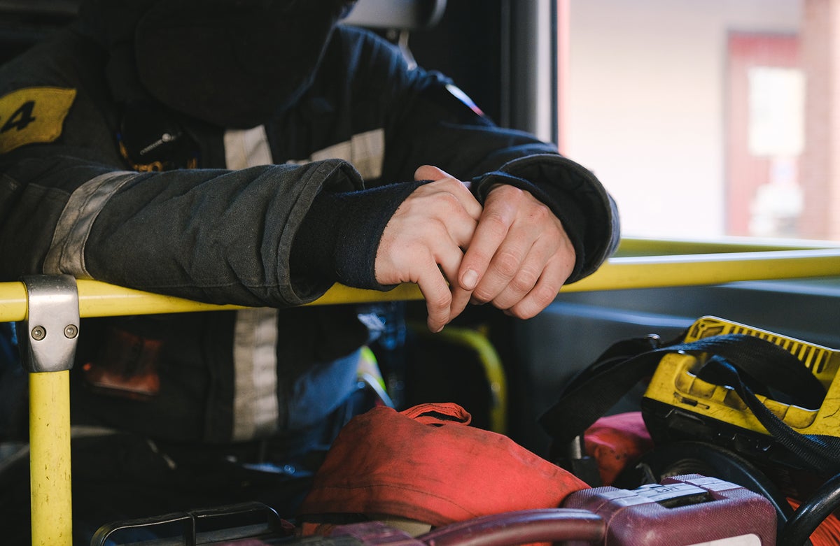 Close-up of fireman's hands and gear