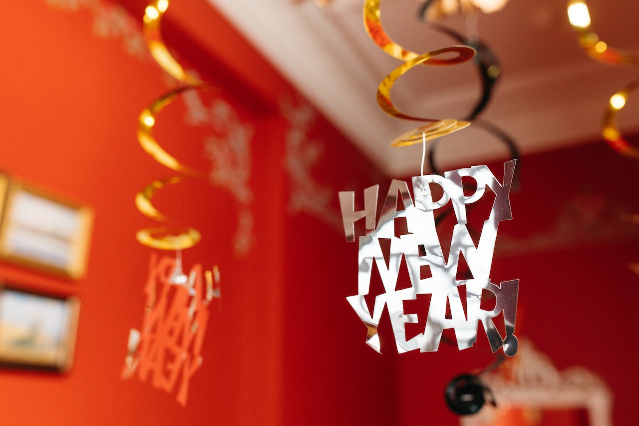 A "Happy New Year" decoration hangs from a ceiling